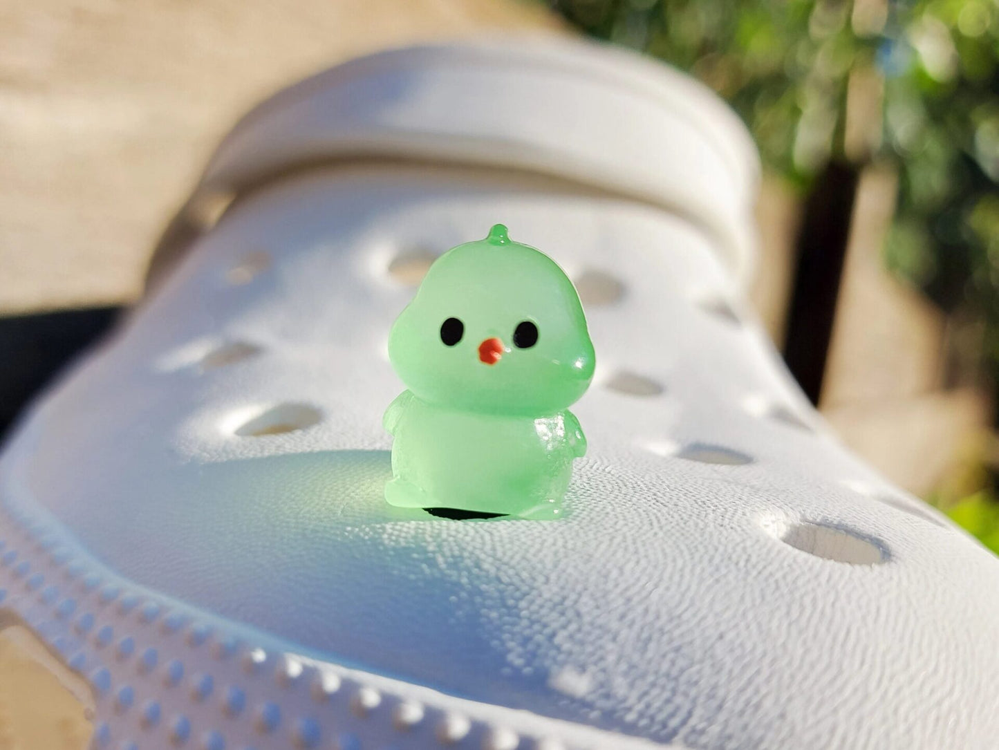 Glow-in-the-dark chicken shoe charms showcasing plump, colorful chickens with playful details like tiny wings and combs. Each charm glows in various neon shades, adding a fun and quirky touch to your shoes, perfect for farm animal lovers.