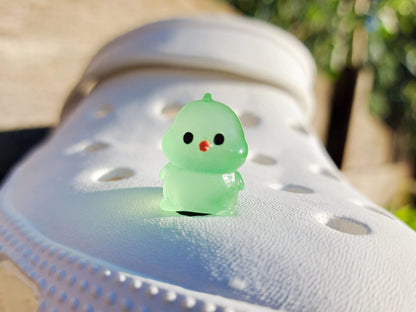 Glow-in-the-dark chicken shoe charms showcasing plump, colorful chickens with playful details like tiny wings and combs. Each charm glows in various neon shades, adding a fun and quirky touch to your shoes, perfect for farm animal lovers.