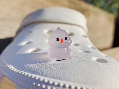 Glow-in-the-dark chicken shoe charms showcasing plump, colorful chickens with playful details like tiny wings and combs. Each charm glows in various neon shades, adding a fun and quirky touch to your shoes, perfect for farm animal lovers.