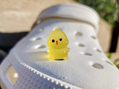 Glow-in-the-dark chicken shoe charms showcasing plump, colorful chickens with playful details like tiny wings and combs. Each charm glows in various neon shades, adding a fun and quirky touch to your shoes, perfect for farm animal lovers.