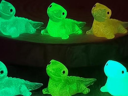 A set of vibrant glow-in-the-dark lizard charms attached to a pair of shoes, featuring tiny, detailed geckos in various colors. These charms, glowing softly in low light, bring a playful and adventurous vibe, perfect for adding a wild touch.