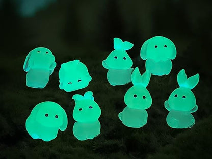 A set of 7 unique glow-in-the-dark bunny charms and 1 carrot charm arranged on a shoe. The bunnies are in various poses, and the carrot sits in the center, all glowing softly in a darkened setting.