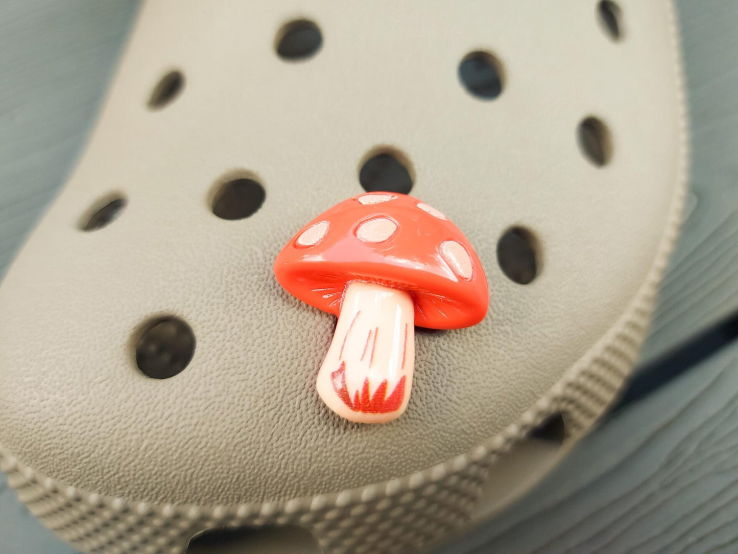Close-up of forest mushroom charms on a shoe shoe, featuring detailed mushroom designs. The charms are securely attached, adding a whimsical, woodland touch to the shoe with a vibrant, nature-inspired look.
