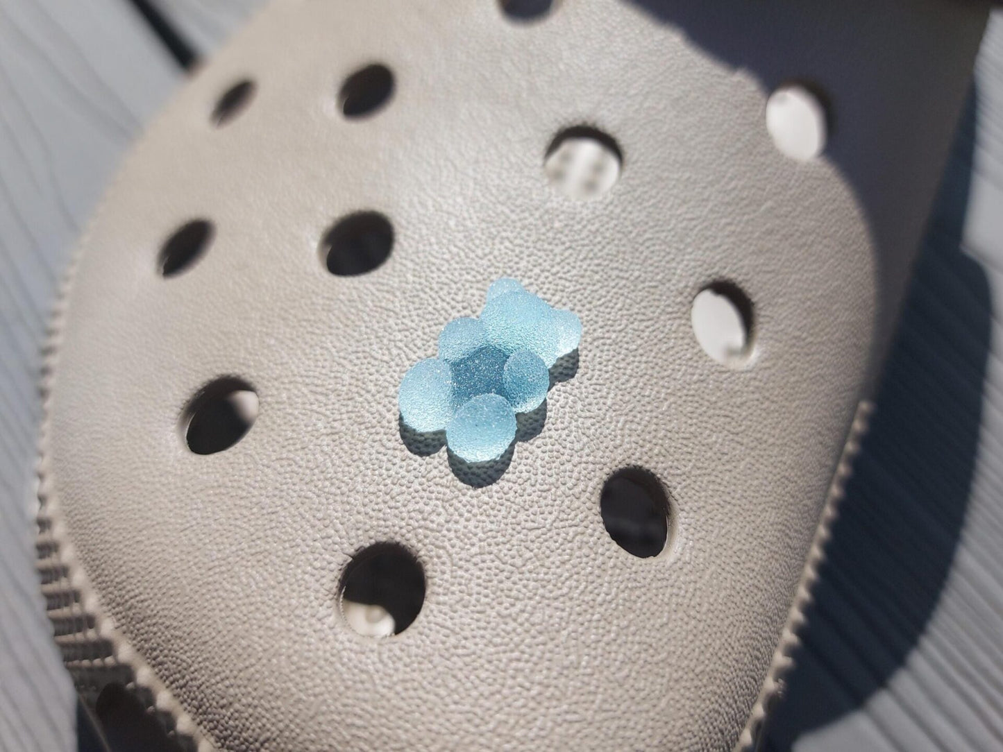 Close-up of sugar gummy bear charms on a shoe shoe, featuring bright, colorful gummy bear designs. The charms are securely attached, adding a playful, candy-inspired touch to the shoe with a fun and vibrant look.