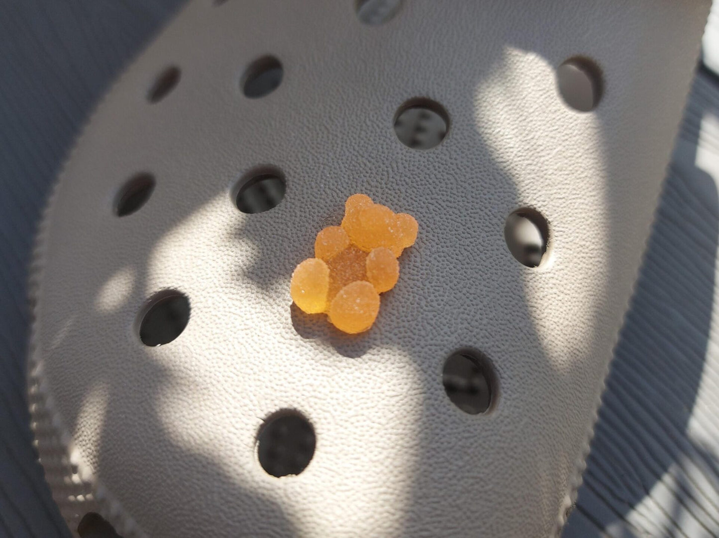 Close-up of sugar gummy bear charms on a shoe shoe, featuring bright, colorful gummy bear designs. The charms are securely attached, adding a playful, candy-inspired touch to the shoe with a fun and vibrant look.