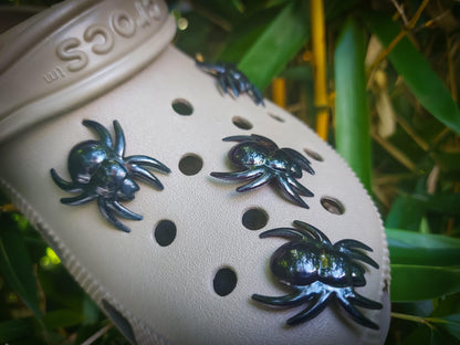 Pair of shoes decorated with realistic, scary spider charms, perfect for Halloween. The detailed spider designs add a creepy and spooky vibe to the shoes, making them an ideal accessory for Halloween festivities or fans of all things frightful.