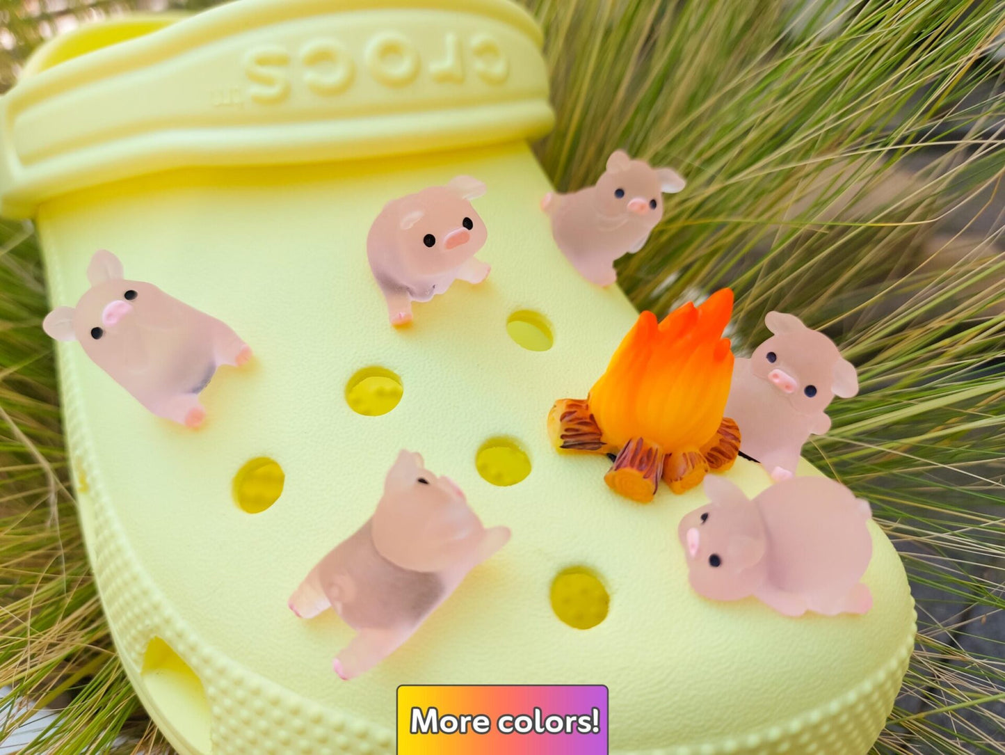 Set of glow-in-the-dark shoe charms featuring adorable pigs around a campfire on a shoe shoe. These playful accessories light up in the dark, adding a unique and whimsical touch to your footwear, perfect for personalizing your shoes.