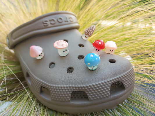 Glow-in-the-dark wild mushroom charms on a shoe shoe. These whimsical accessories light up in the dark, adding a magical and nature-inspired touch to your footwear. Perfect for customizing your shoes with a unique forest theme.