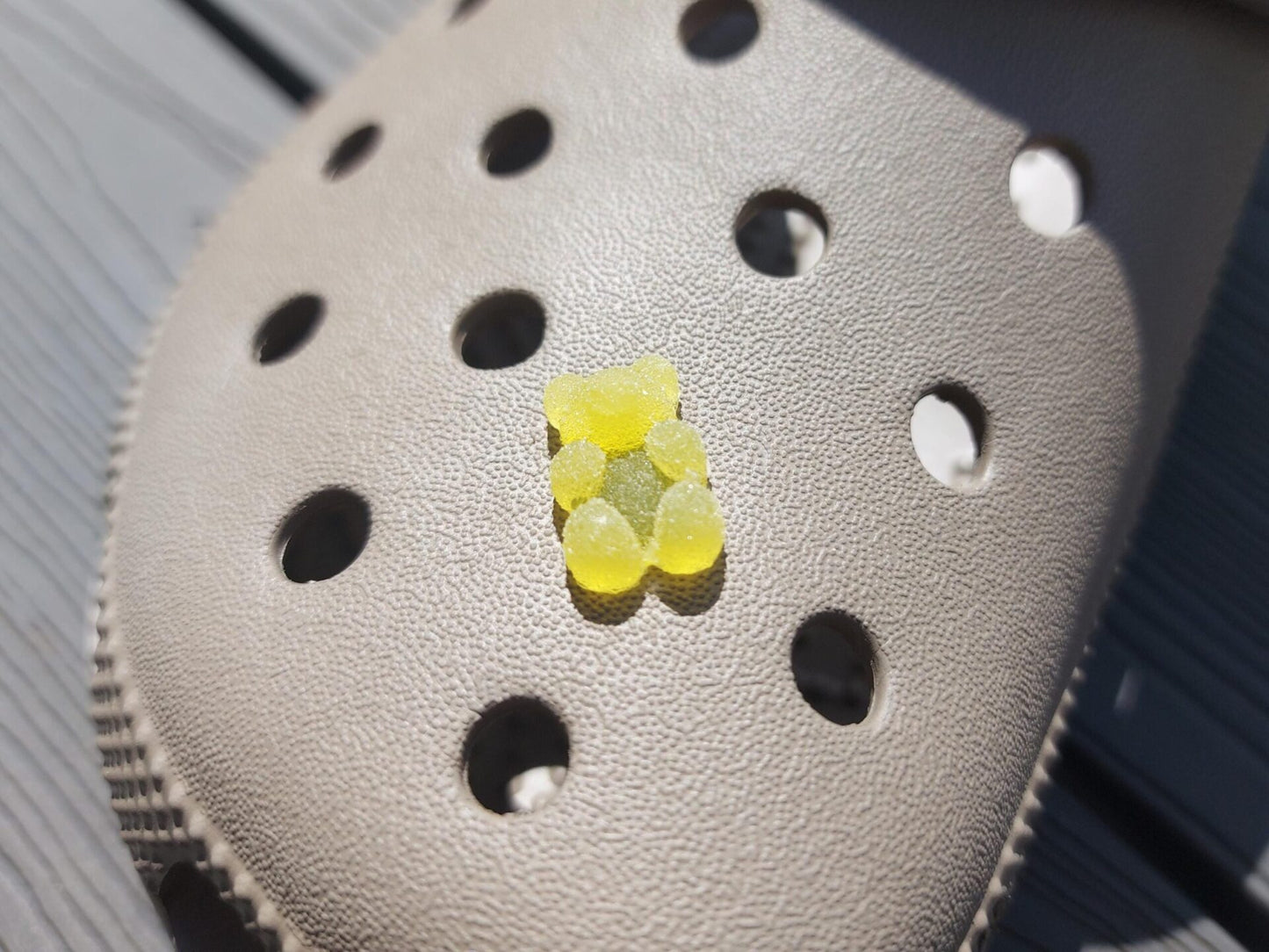 Close-up of sugar gummy bear charms on a shoe shoe, featuring bright, colorful gummy bear designs. The charms are securely attached, adding a playful, candy-inspired touch to the shoe with a fun and vibrant look.