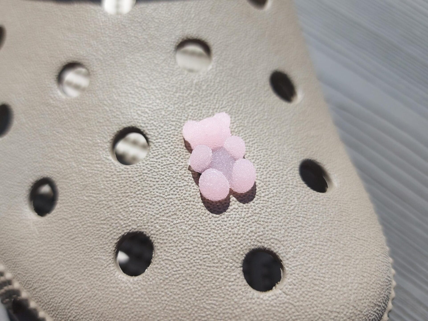 Close-up of sugar gummy bear charms on a shoe shoe, featuring bright, colorful gummy bear designs. The charms are securely attached, adding a playful, candy-inspired touch to the shoe with a fun and vibrant look.