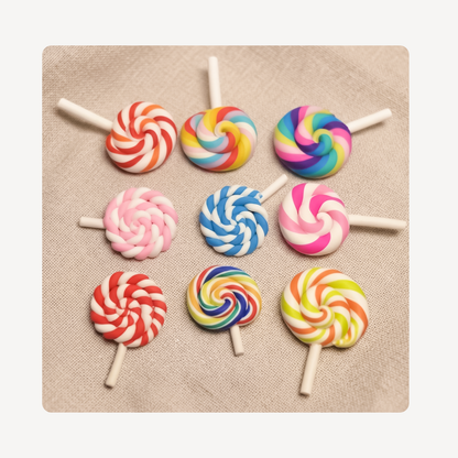 Nine colorful spiral lollipop clog charms arranged in a 3x3 grid on a beige textured fabric background.