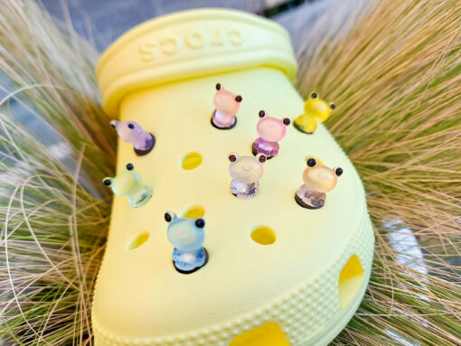 Glow-in-the-dark frog charms on a yellow Crocs shoe. These playful and luminous accessories add a fun, froggy touch to your footwear, making them perfect for customizing your Crocs with a whimsical and adventurous vibe.