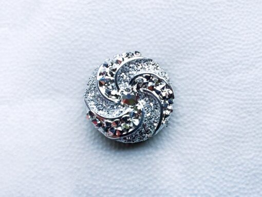Colorful crystal round charms with sparkly rhinestones on a brown Croc shoe. These vibrant and glittering accessories add a dazzling touch to your footwear, perfect for customizing your Crocs with a unique and eye-catching sparkle.