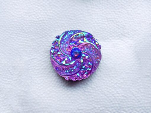 Colorful crystal round charms with sparkly rhinestones on a brown Croc shoe. These vibrant and glittering accessories add a dazzling touch to your footwear, perfect for customizing your Crocs with a unique and eye-catching sparkle.