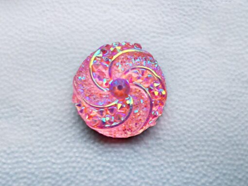 Colorful crystal round charms with sparkly rhinestones on a brown Croc shoe. These vibrant and glittering accessories add a dazzling touch to your footwear, perfect for customizing your Crocs with a unique and eye-catching sparkle.