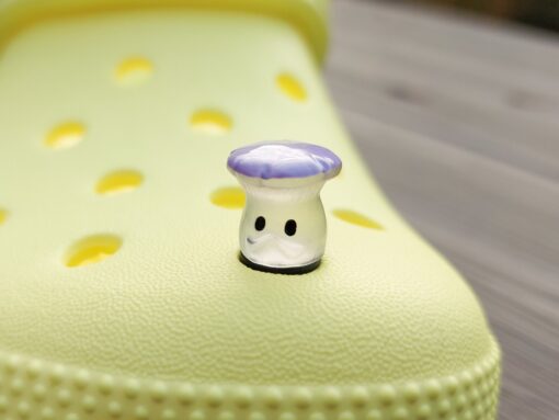 Glow-in-the-dark wild mushroom charms on a Croc shoe. These whimsical accessories light up in the dark, adding a magical and nature-inspired touch to your footwear. Perfect for customizing your Crocs with a unique forest theme.