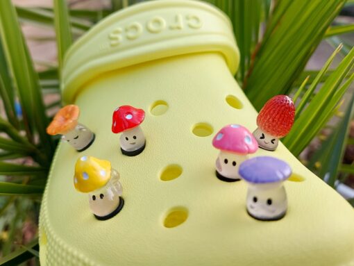 Glow-in-the-dark wild mushroom charms on a Croc shoe. These whimsical accessories light up in the dark, adding a magical and nature-inspired touch to your footwear. Perfect for customizing your Crocs with a unique forest theme.
