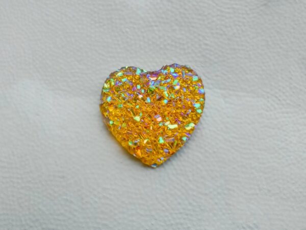 Sparkly and glittery rhinestone shoe charms in heart shapes on a pair of Crocs shoes. Different colors such as silver, gold, rose, jade, amethyst, diamond.