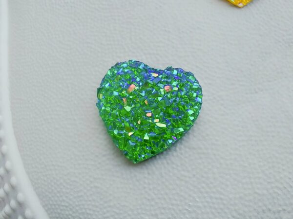 Sparkly and glittery rhinestone shoe charms in heart shapes on a pair of Crocs shoes. Different colors such as silver, gold, rose, jade, amethyst, diamond.