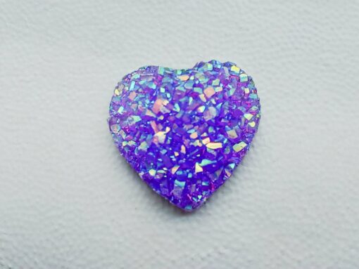 Sparkly and glittery rhinestone shoe charms in heart shapes on a pair of Crocs shoes. Different colors such as silver, gold, rose, jade, amethyst, diamond.