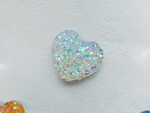 Sparkly and glittery rhinestone shoe charms in heart shapes on a pair of Crocs shoes. Different colors such as silver, gold, rose, jade, amethyst, diamond.