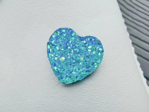 Sparkly and glittery rhinestone shoe charms in heart shapes on a pair of Crocs shoes. Different colors such as silver, gold, rose, jade, amethyst, diamond.