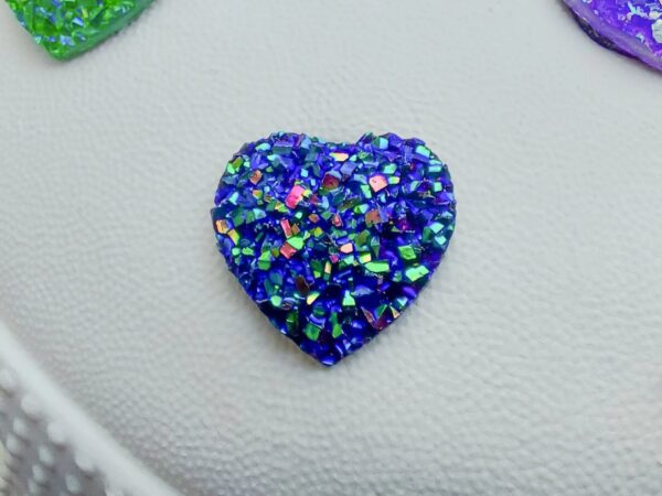 Sparkly and glittery rhinestone shoe charms in heart shapes on a pair of Crocs shoes. Different colors such as silver, gold, rose, jade, amethyst, diamond.