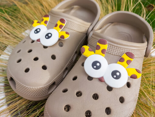 Close-up of playful giraffe shoe charms featuring large eyes, a small nose, and giraffe antlers, perfect for adding a safari-inspired, whimsical touch to your shoes.