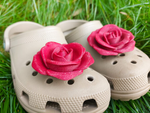 Close-up view of shoes adorned with 3D-printed red rose charms on the front, adding a bold, floral touch. Each charm features detailed petal design, adding elegance and color to the shoes. Perfect for making a stylish statement on casual footwear.