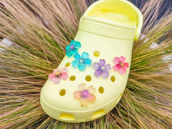 Glow-in-the-dark cherry blossom shoe charms in six colors—pink, dark pink, purple, blue, green, and orange—adding a soft, luminous effect to shoes with flower-themed elegance.