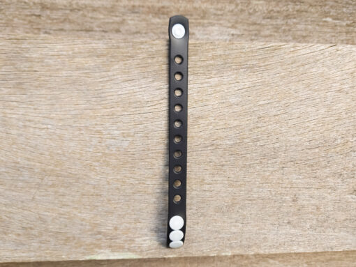 A flexible, adjustable bracelet with multiple charm slots, available in a range of vibrant colors for a personalized look.
