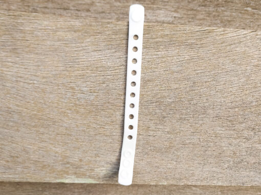 A flexible, adjustable bracelet with multiple charm slots, available in a range of vibrant colors for a personalized look.