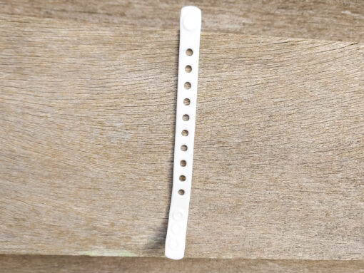A flexible, adjustable bracelet with multiple charm slots, available in a range of vibrant colors for a personalized look.